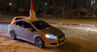 Otomobilinin tavanına yaptığı 'kardan adam' ile şehir turu attı