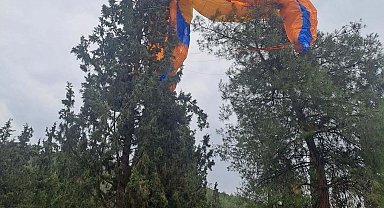 Paraşütü ağaca takıldı, itfaiye kurtardı