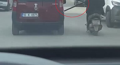 Motosikleti arızalanan sürücü, başka araçtan uzatılan emniyet kemerini tutup seyretti