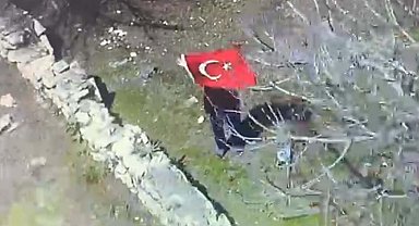 Elinde Türk bayrağı ile polis helikopterini selamlayan kadına plaket